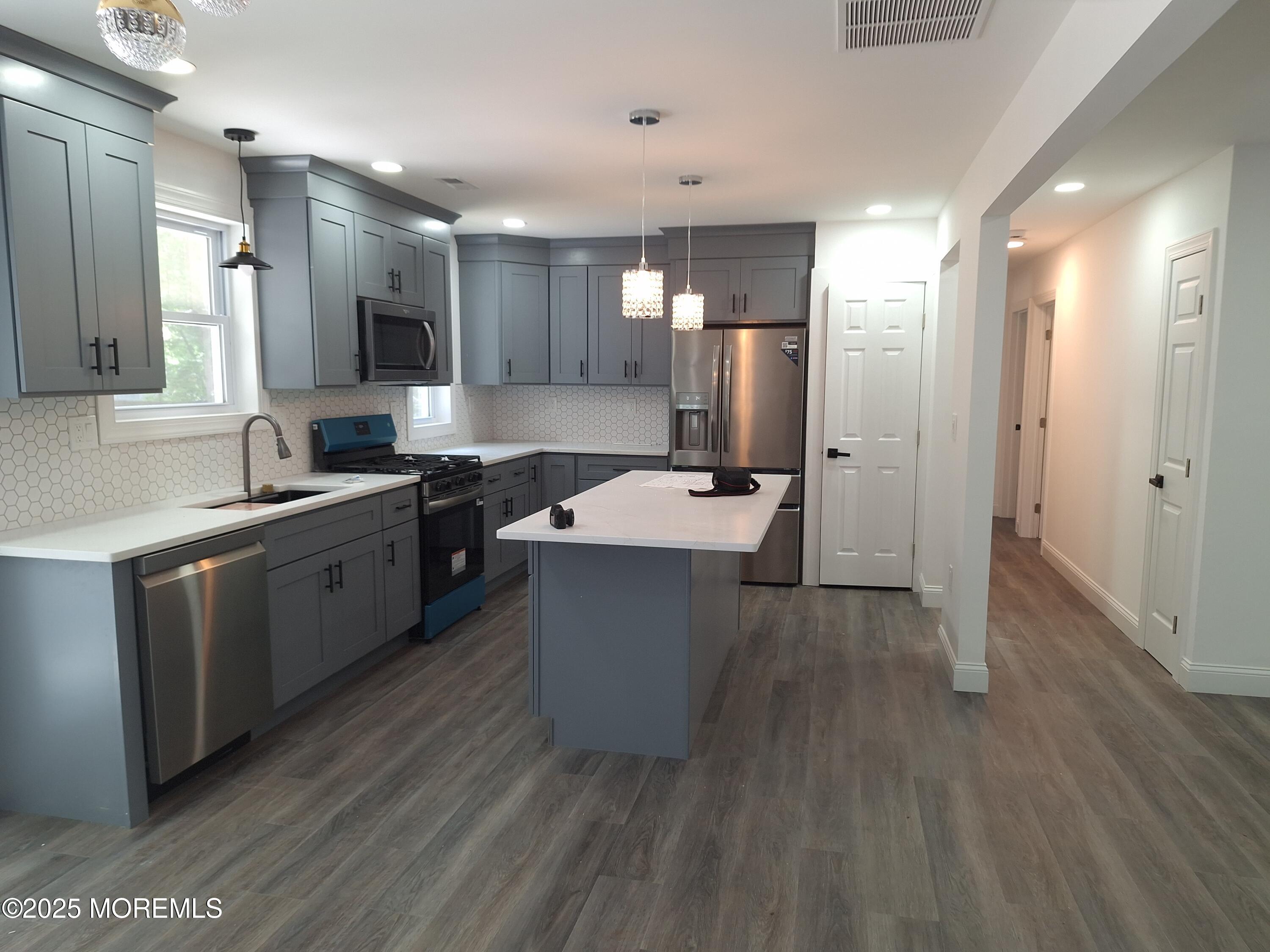 414 Oak Tree Road Freehold, NJ 07728 - Photo 5 of 25 a large kitchen with a lot of counter space and stainless steel appliances