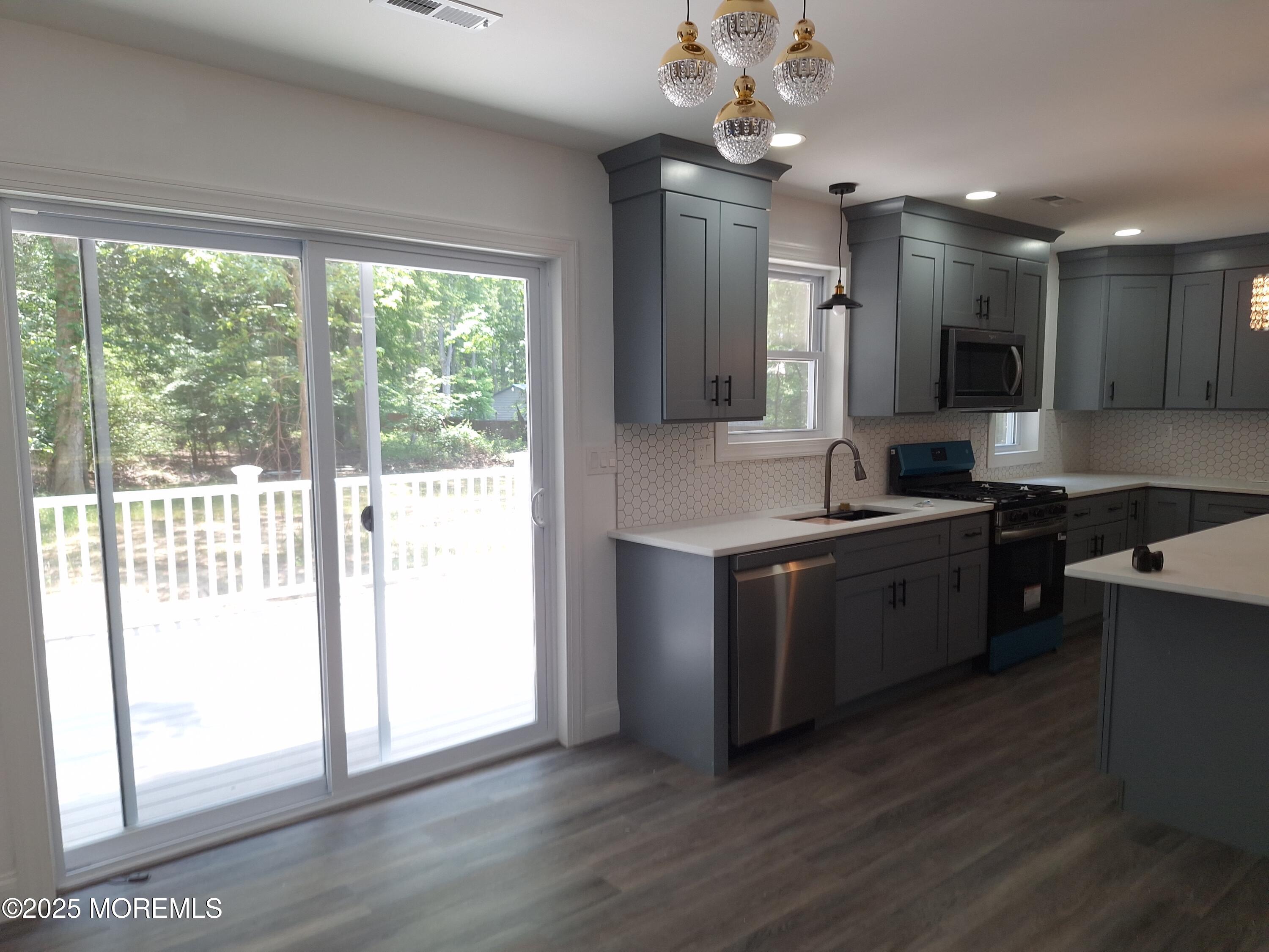 414 Oak Tree Road Freehold, NJ 07728 - Photo 6 of 25 a kitchen with a refrigerator and a sink