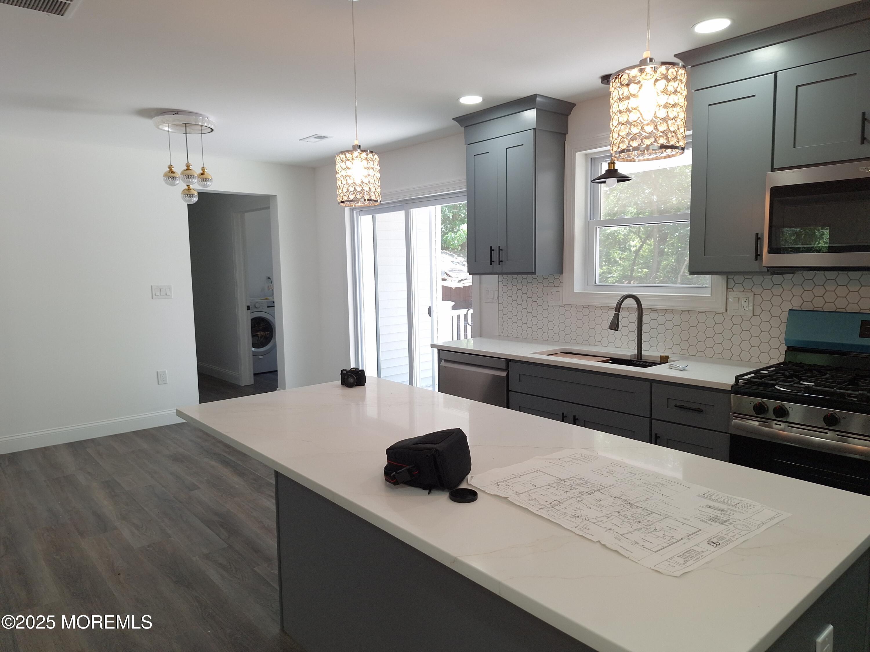 414 Oak Tree Road Freehold, NJ 07728 - Photo 7 of 25 a kitchen with a sink a stove and refrigerator