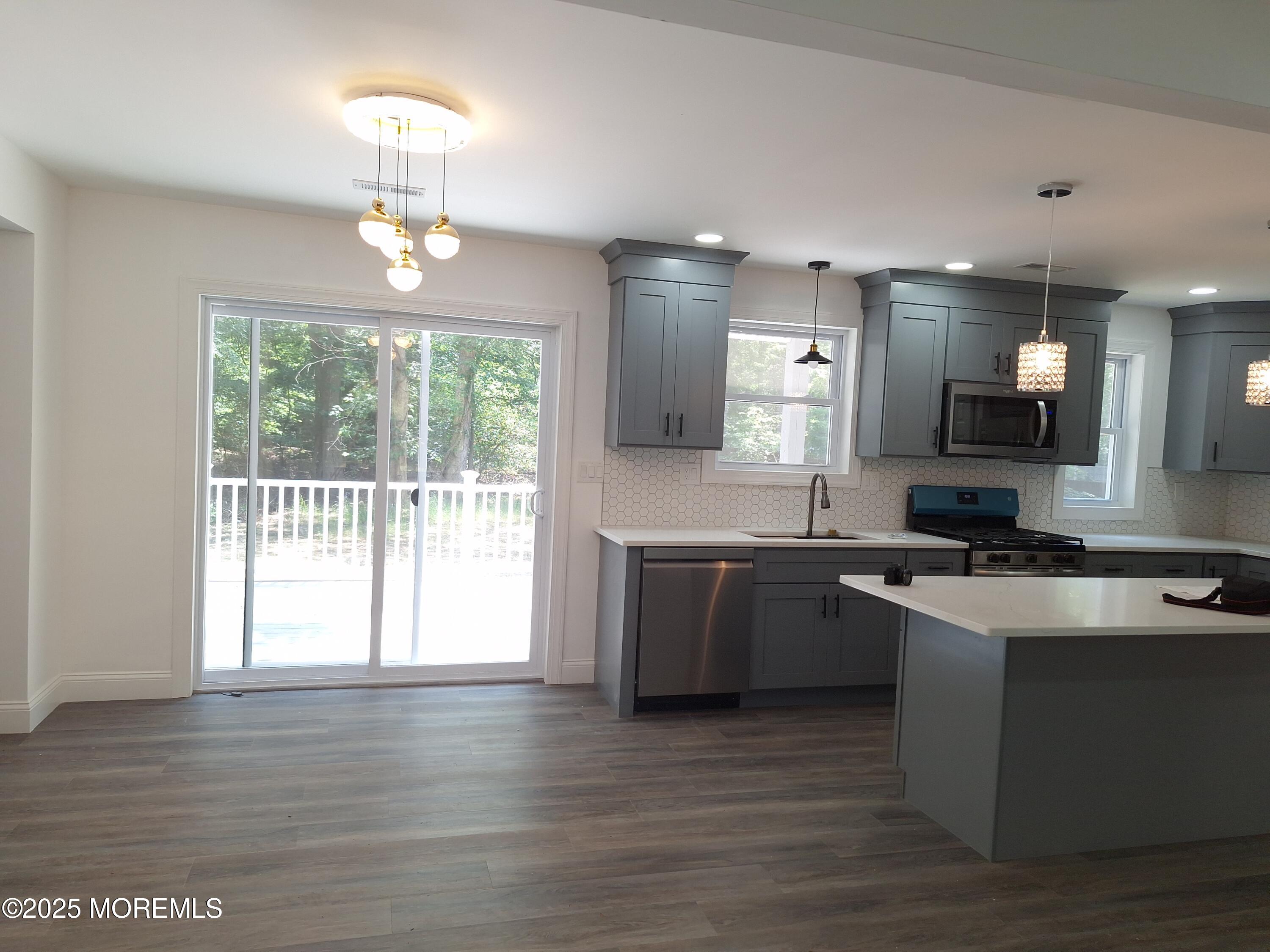 414 Oak Tree Road Freehold, NJ 07728 - Photo 8 of 25 a kitchen with stainless steel appliances granite countertop a sink stove and refrigerator