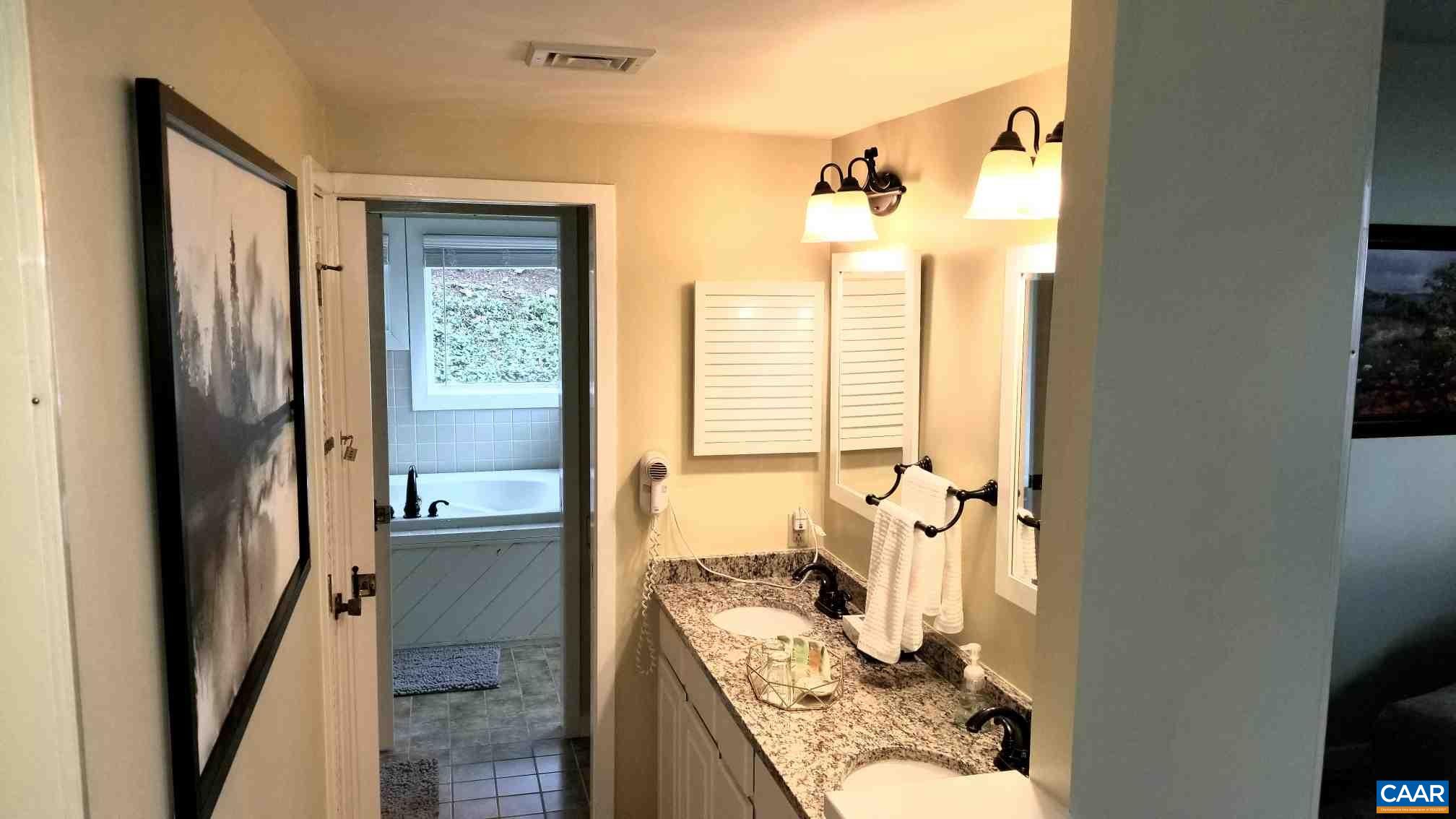 1722 High Ridge Roseland, VA 22967 - Photo 11 of 23 a bathroom with a granite countertop sink mirror and a bathtub