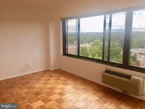 a front view of a building with street and sign board