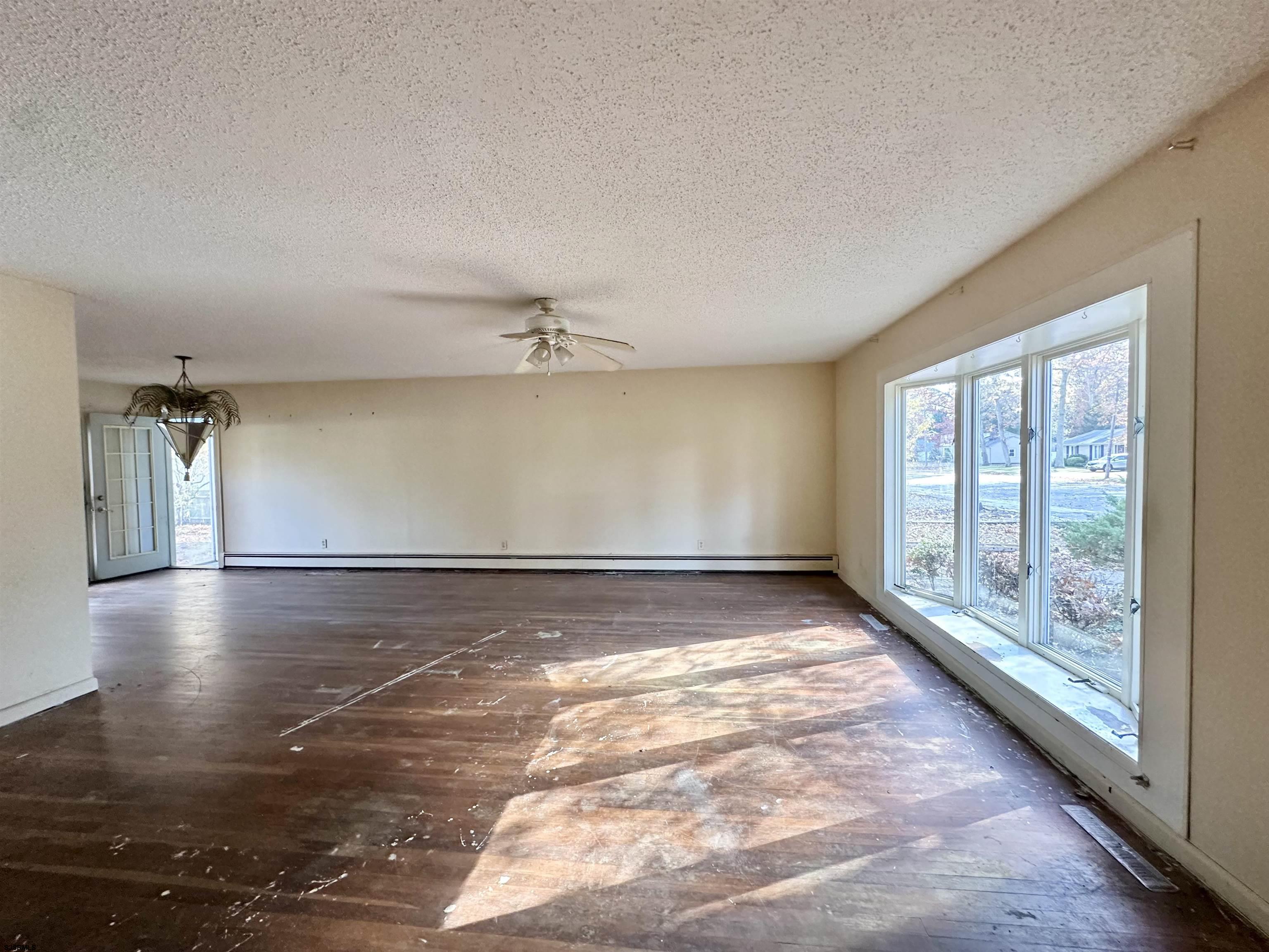 928 Traymore Parkway Absecon, NJ 08201 - Photo 2 of 25 wooden floor in an empty room with a window