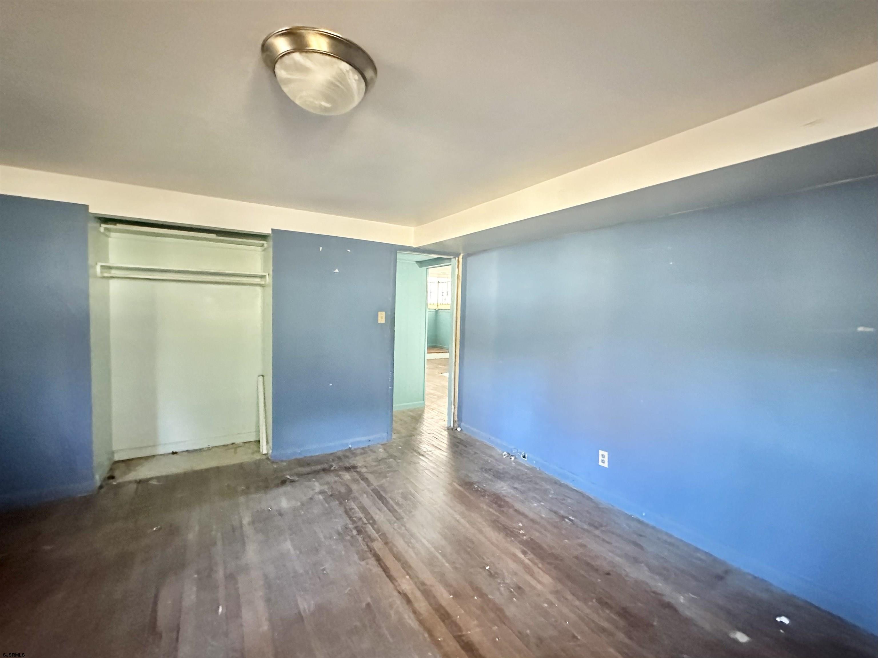 928 Traymore Parkway Absecon, NJ 08201 - Photo 24 of 25 an empty room with wooden floor and windows