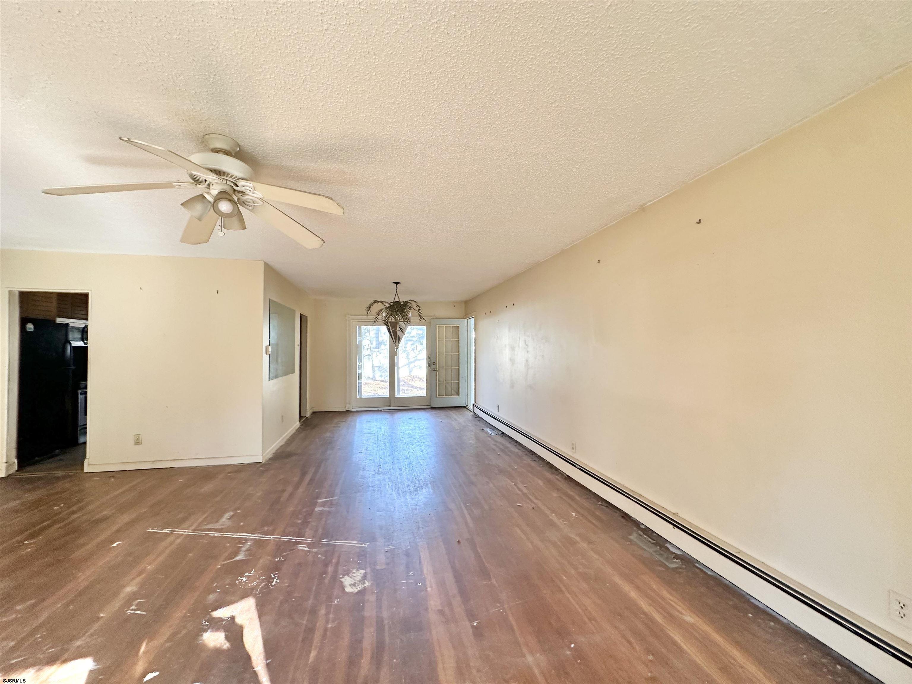 928 Traymore Parkway Absecon, NJ 08201 - Photo 4 of 25 wooden floor in an empty room with a window