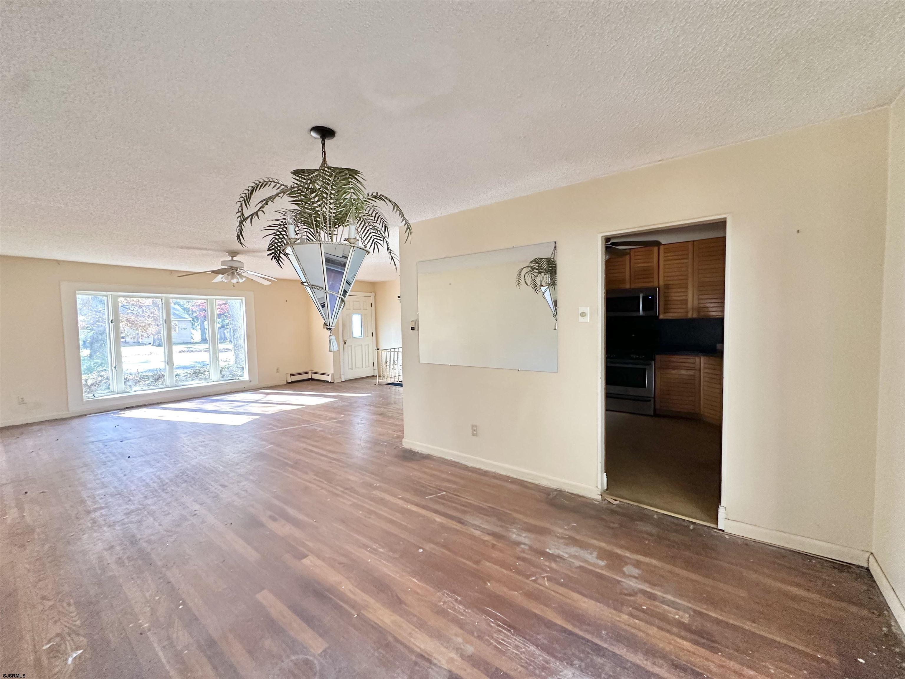 928 Traymore Parkway Absecon, NJ 08201 - Photo 5 of 25 wooden floor in an empty room with a window