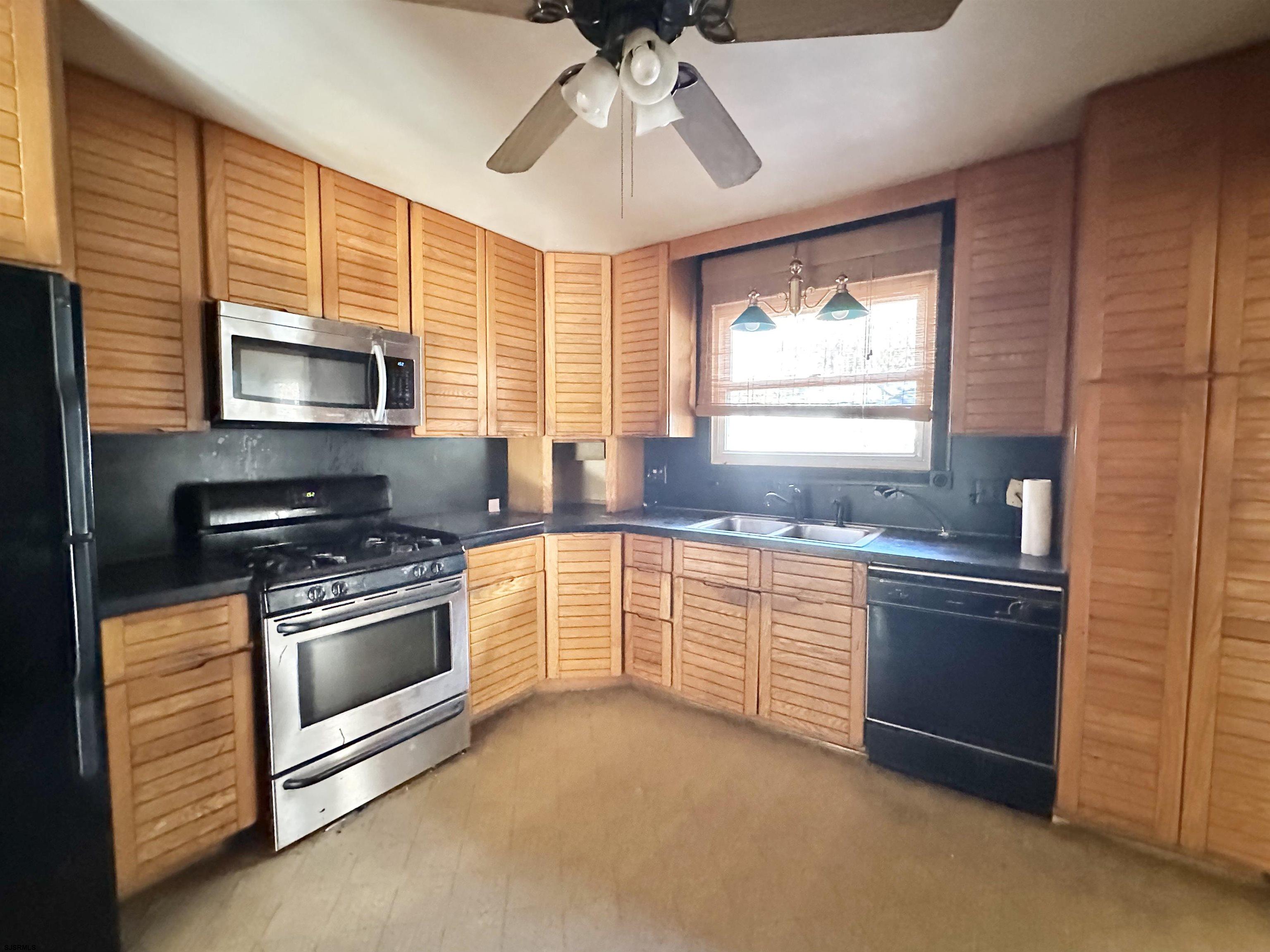 928 Traymore Parkway Absecon, NJ 08201 - Photo 6 of 25 a kitchen with stainless steel appliances granite countertop a stove and a sink