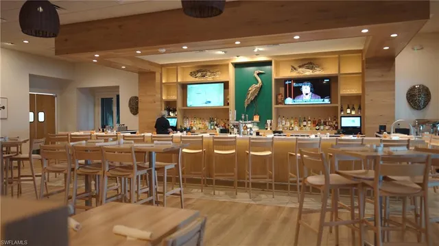 a large dining space with furniture a kitchen and chandelier