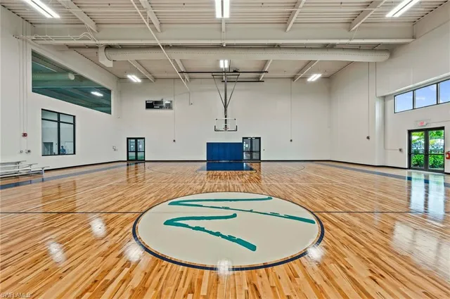 a view of a living room and kitchen with furniture and wooden floor