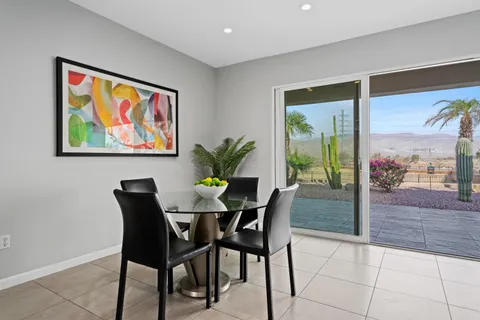 a view of a dining room with furniture and a potted plant