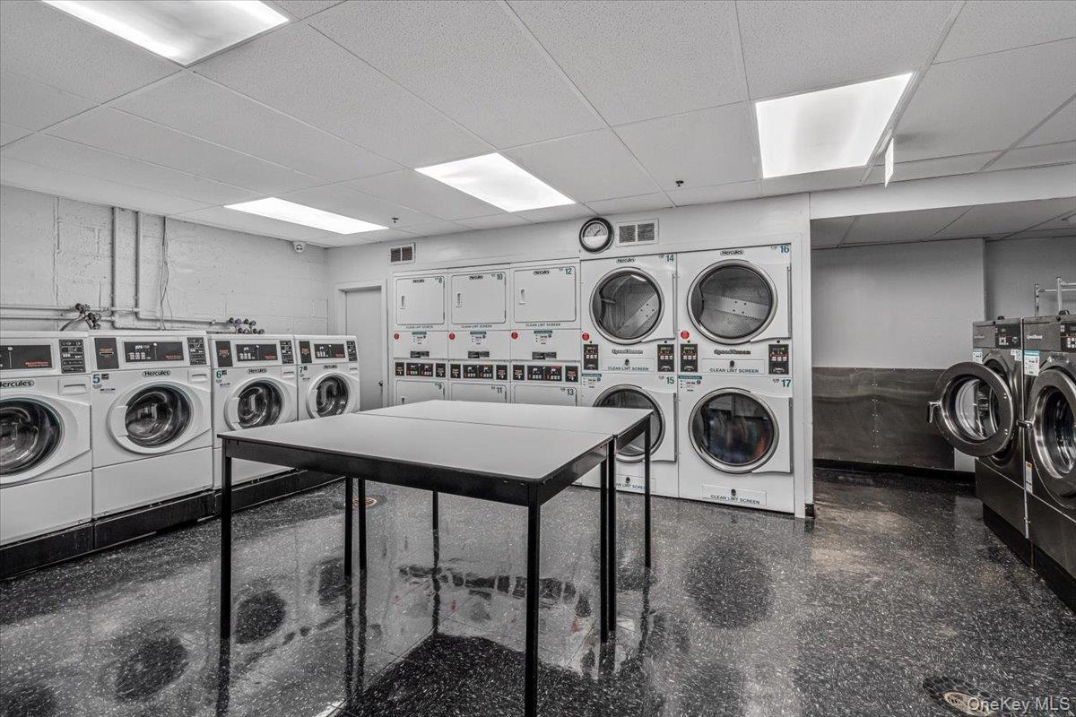 99-40 63rd Road, Unit 1Z Queens, NY 11374 - Photo 21 of 25 Shared laundry with stacked washer and clothes dryer and washer and dryer