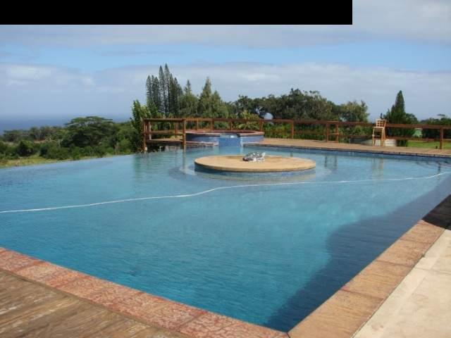 830 West Kuiaha Road Haiku, HI 96708 - Photo 1 of 15 a view of a swimming pool with an outdoor seating and trees in the background