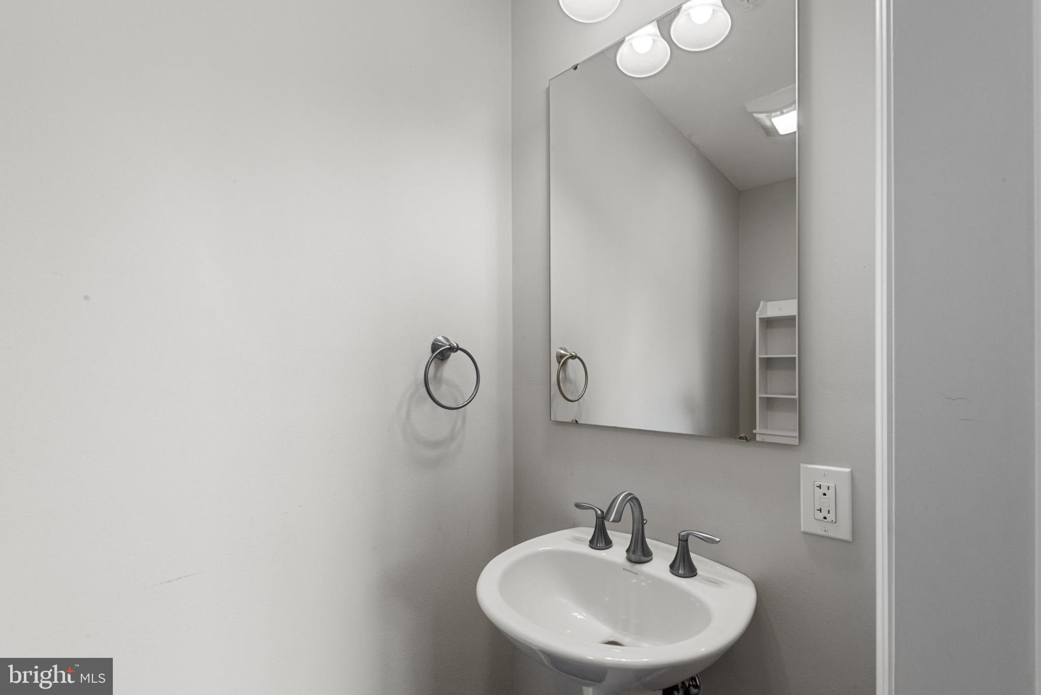 910 Rosedale Avenue Rosedale, MD 21237 - Photo 12 of 41 a bathroom with a sink and mirror