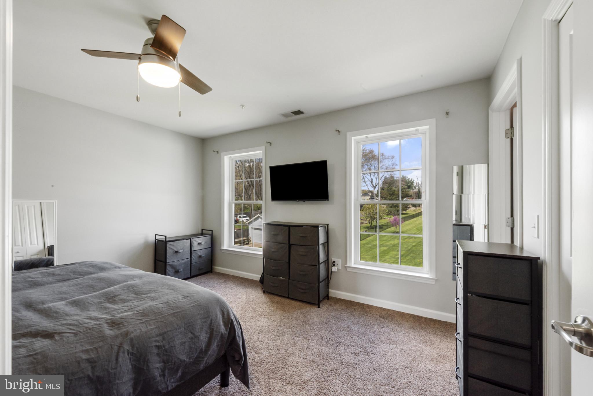 910 Rosedale Avenue Rosedale, MD 21237 - Photo 14 of 41 a bedroom with a bed and a flat tv screen on dresser