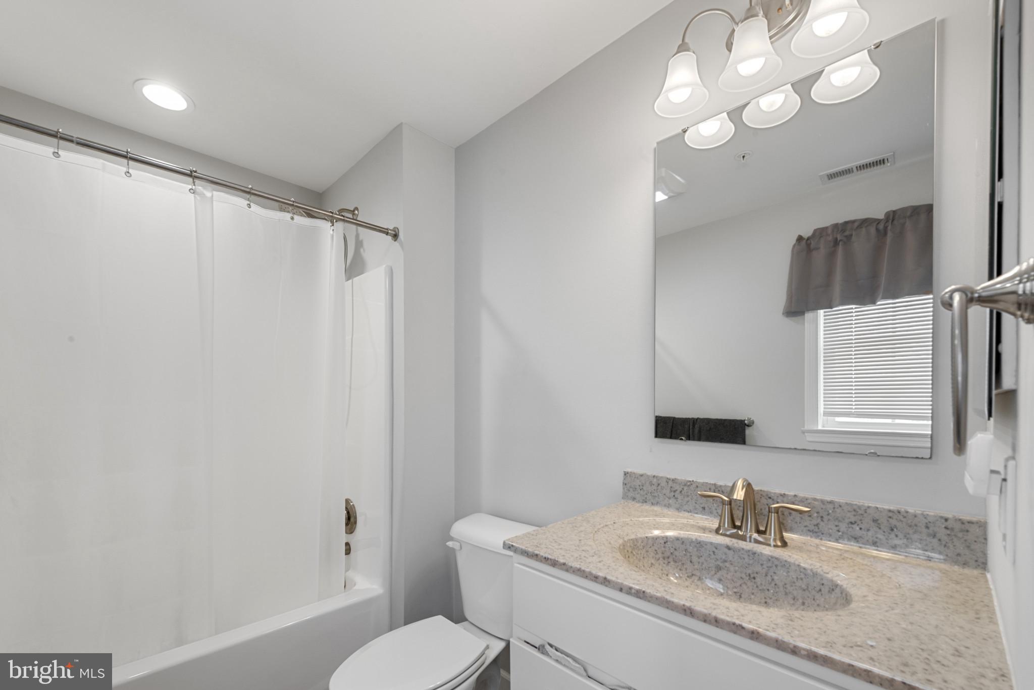 910 Rosedale Avenue Rosedale, MD 21237 - Photo 19 of 41 a bathroom with a granite countertop sink toilet and shower