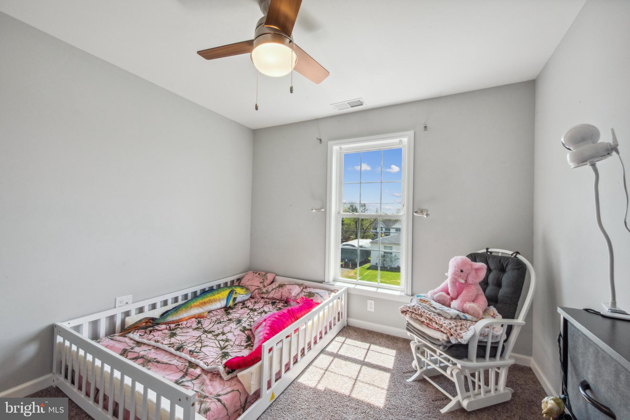 910 Rosedale Avenue Rosedale, MD 21237 - Photo 27 of 41 a living room with a baby crib furniture and a chandelier