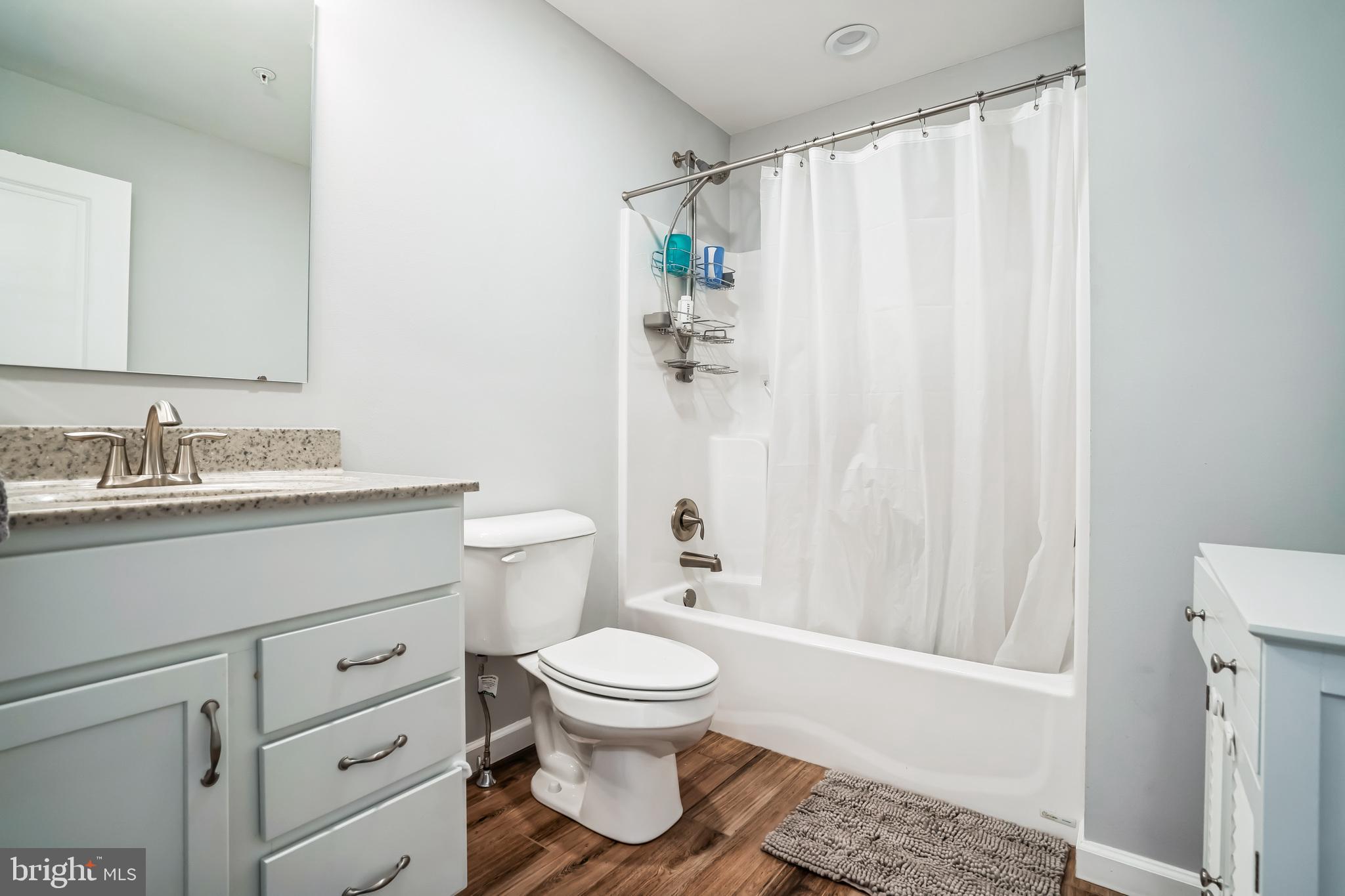 910 Rosedale Avenue Rosedale, MD 21237 - Photo 30 of 41 a bathroom with a granite countertop sink toilet and shower