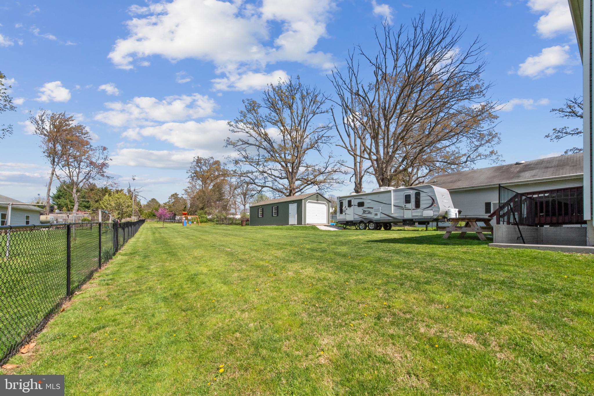 910 Rosedale Avenue Rosedale, MD 21237 - Photo 40 of 41 a front view of a house with a garden and trees