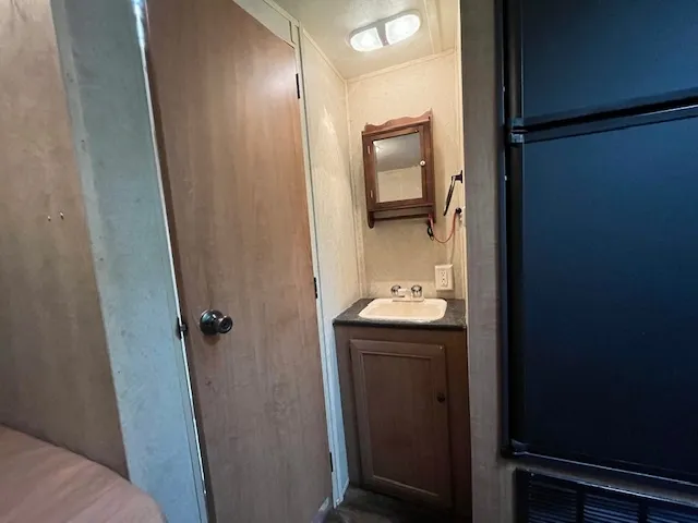 a bathroom with a granite countertop bathtub and a toilet
