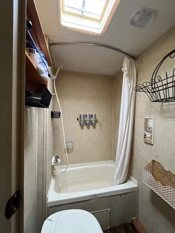 a view of empty room with window and wooden floor