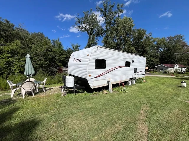 a kitchen with stainless steel appliances granite countertop a sink dishwasher a stove a refrigerator and a dining table with wooden floor
