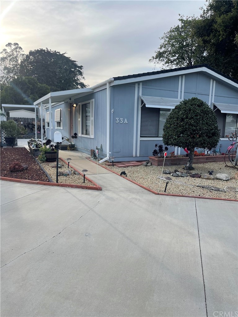 a view of a house with backyard and sitting area