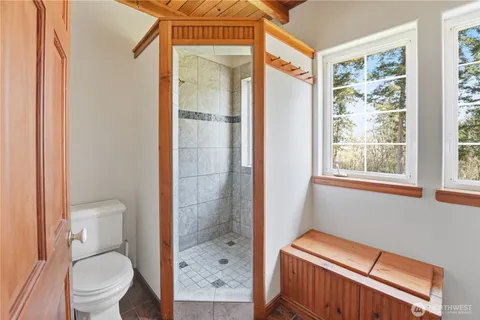 a bathroom with a toilet and a shower