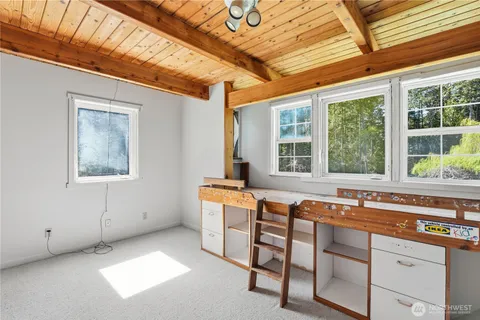 a living room with furniture and large windows