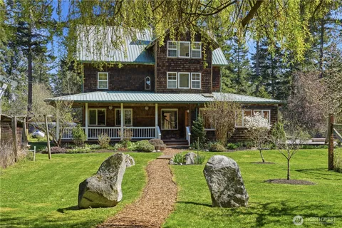 a front view of a house with a yard table and chairs