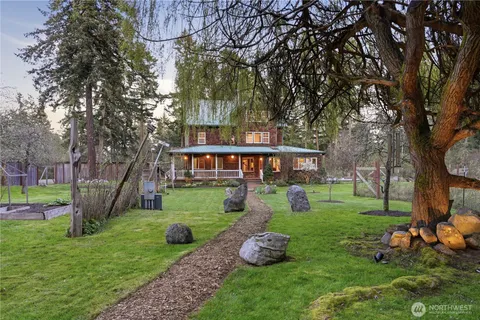 a view of a house with a yard porch and sitting area