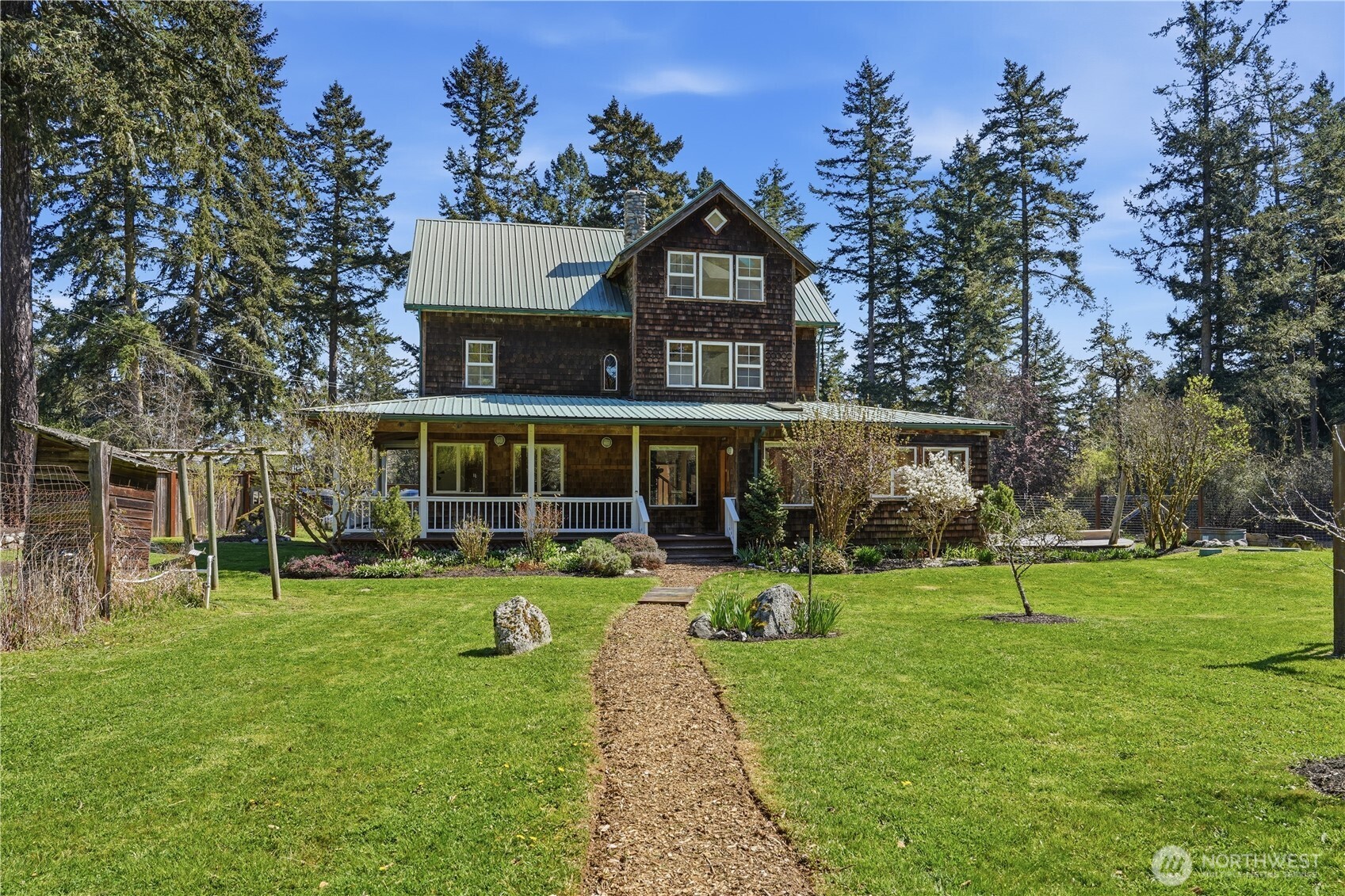 1763 Center Road Lopez Island, WA 98261 - Photo 3 of 40 a front view of a house with a yard