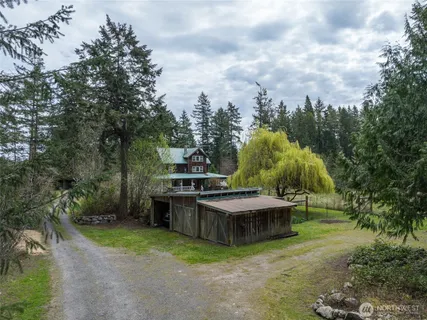 a view of a backyard with swimming pool