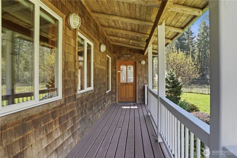 a view of a porch with wooden floor and outdoor space