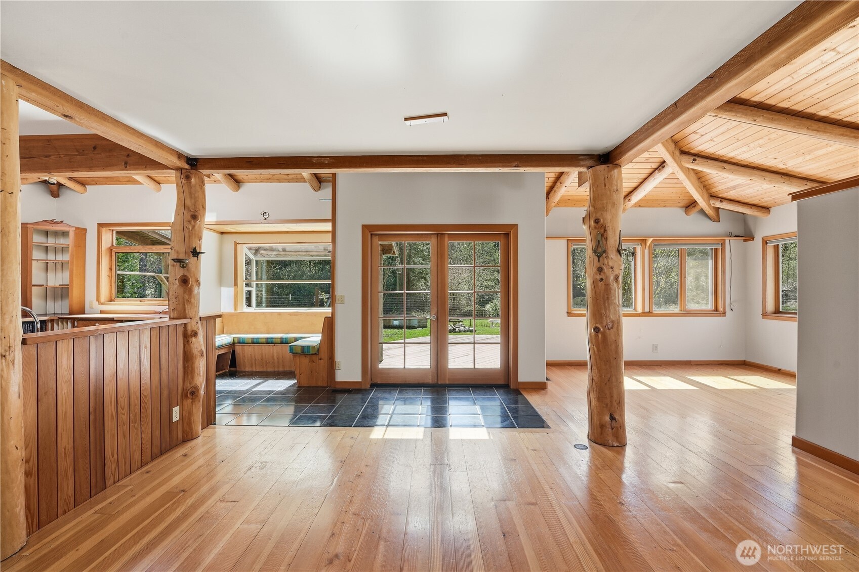 1763 Center Road Lopez Island, WA 98261 - Photo 6 of 40 an empty room with wooden floor and windows