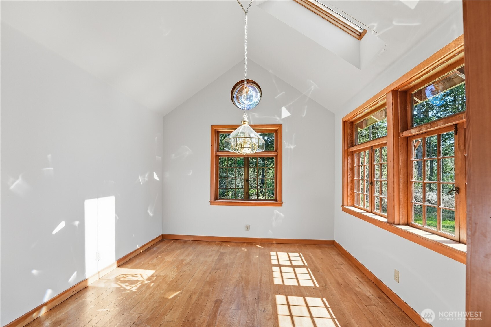 1763 Center Road Lopez Island, WA 98261 - Photo 8 of 40 a view of an empty room with wooden floor and windows