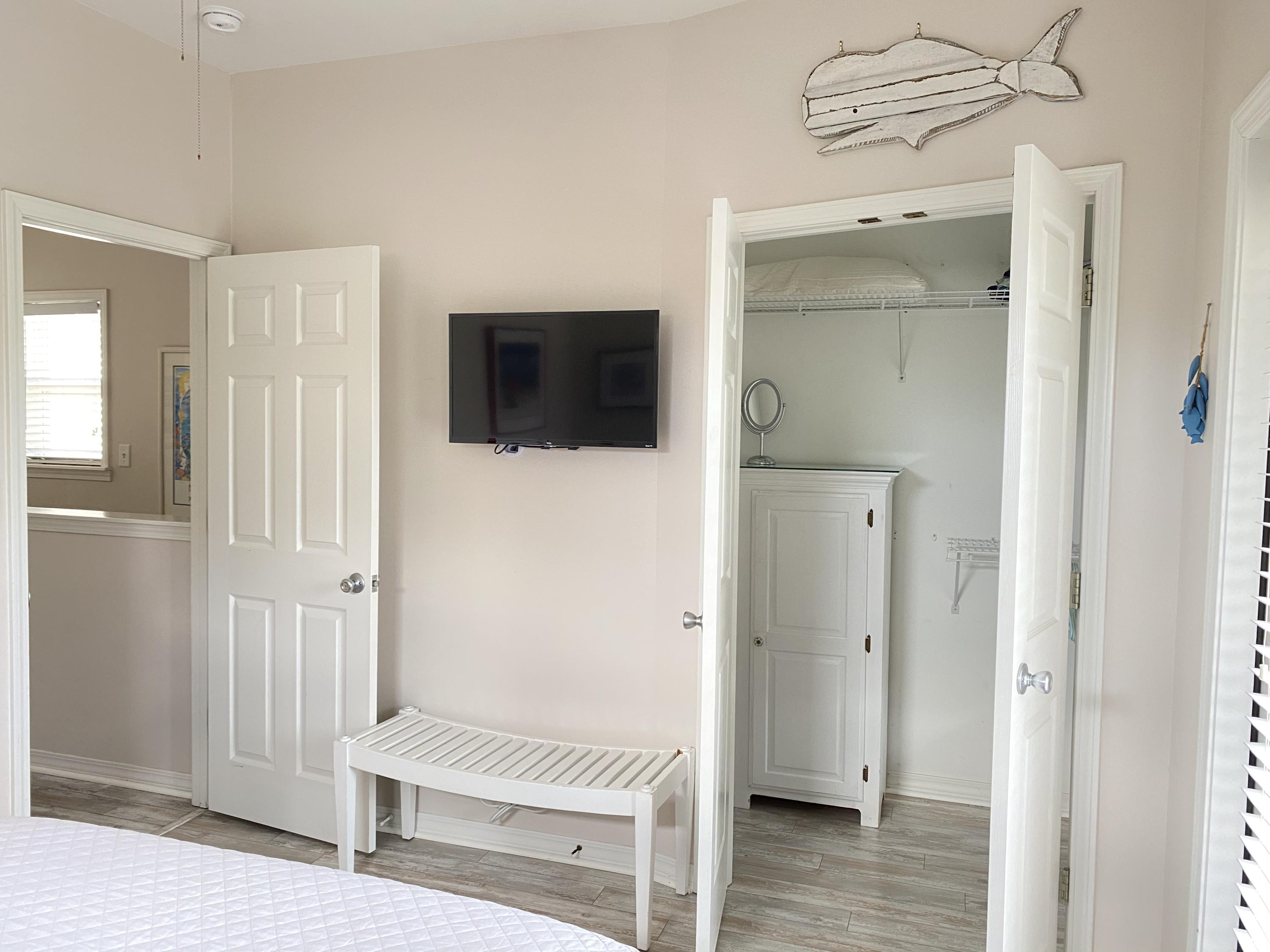 57 Emerald Dunes Circle Santa Rosa Beach, FL 32459 - Photo 18 of 26 a living room with a flat screen tv and a wooden floor