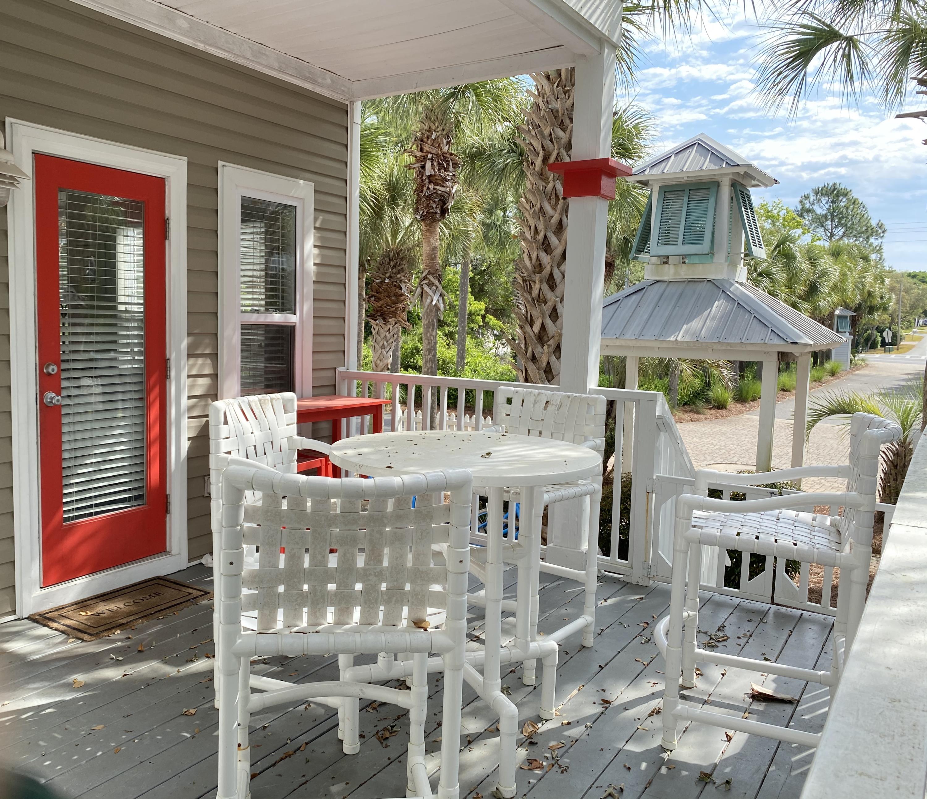 57 Emerald Dunes Circle Santa Rosa Beach, FL 32459 - Photo 21 of 26 a view of an chairs and tables in the patio in front of the house