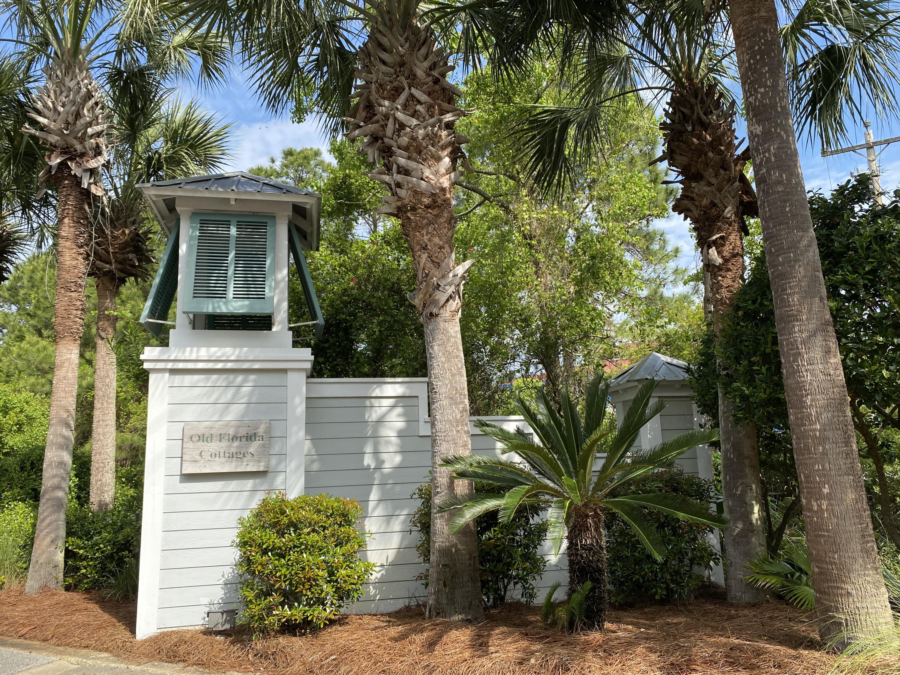 57 Emerald Dunes Circle Santa Rosa Beach, FL 32459 - Photo 25 of 26 front view of a house with a potted plants and palm trees