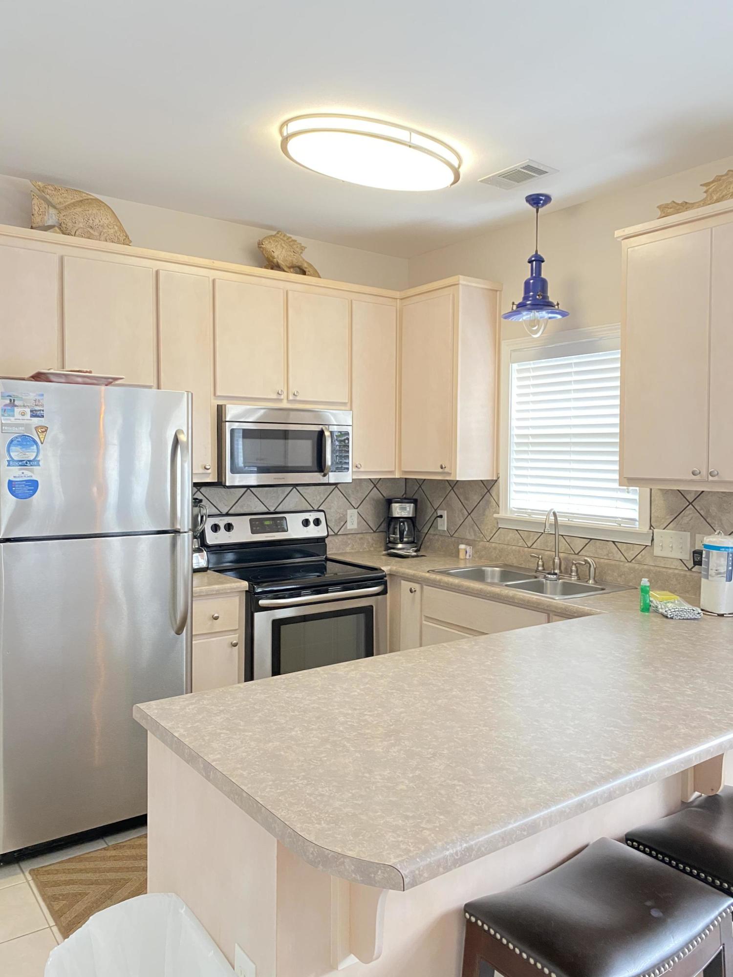 57 Emerald Dunes Circle Santa Rosa Beach, FL 32459 - Photo 8 of 26 a kitchen with a refrigerator a stove a sink and a refrigerator