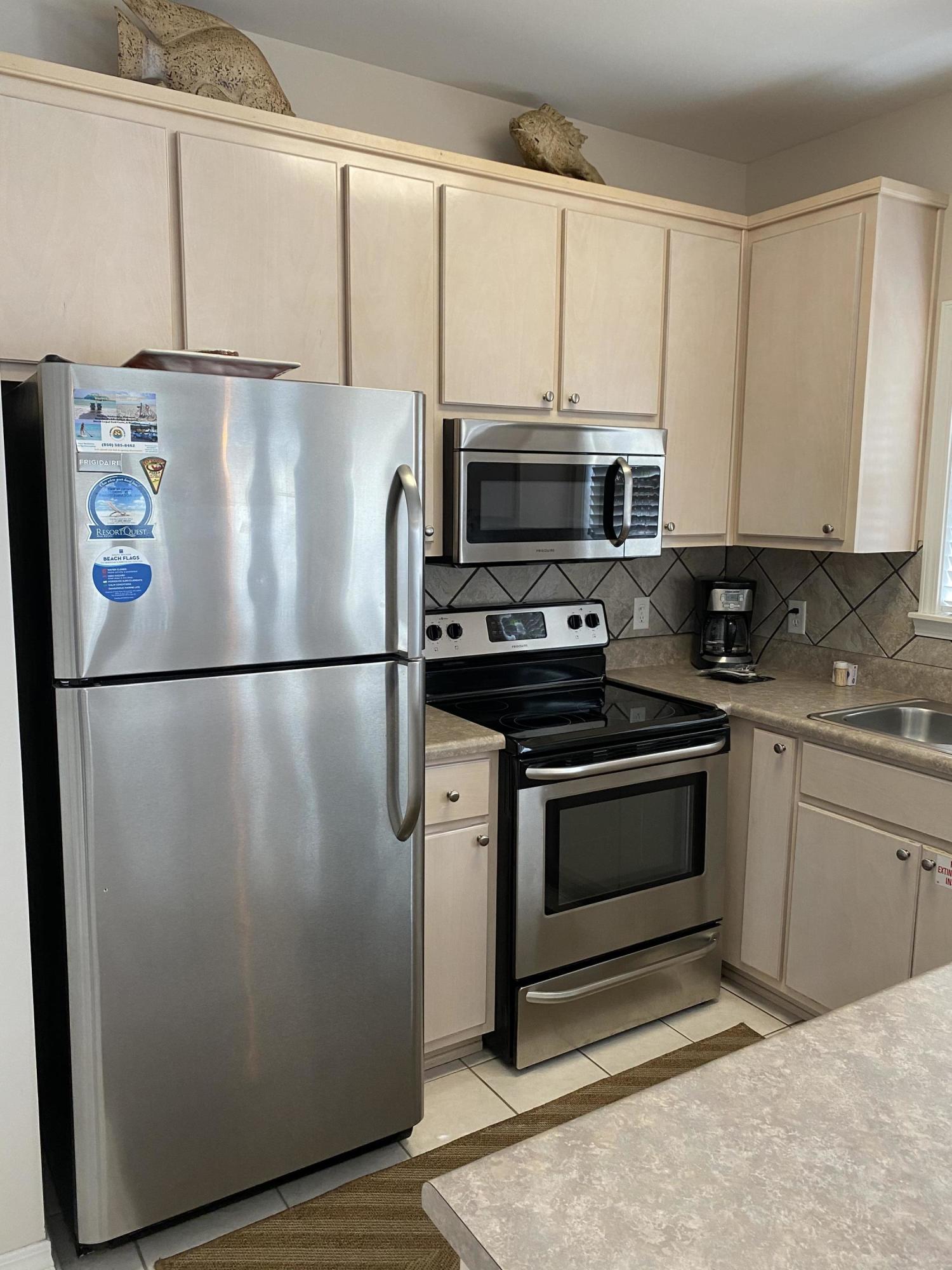 57 Emerald Dunes Circle Santa Rosa Beach, FL 32459 - Photo 9 of 26 a white refrigerator freezer sitting in a kitchen