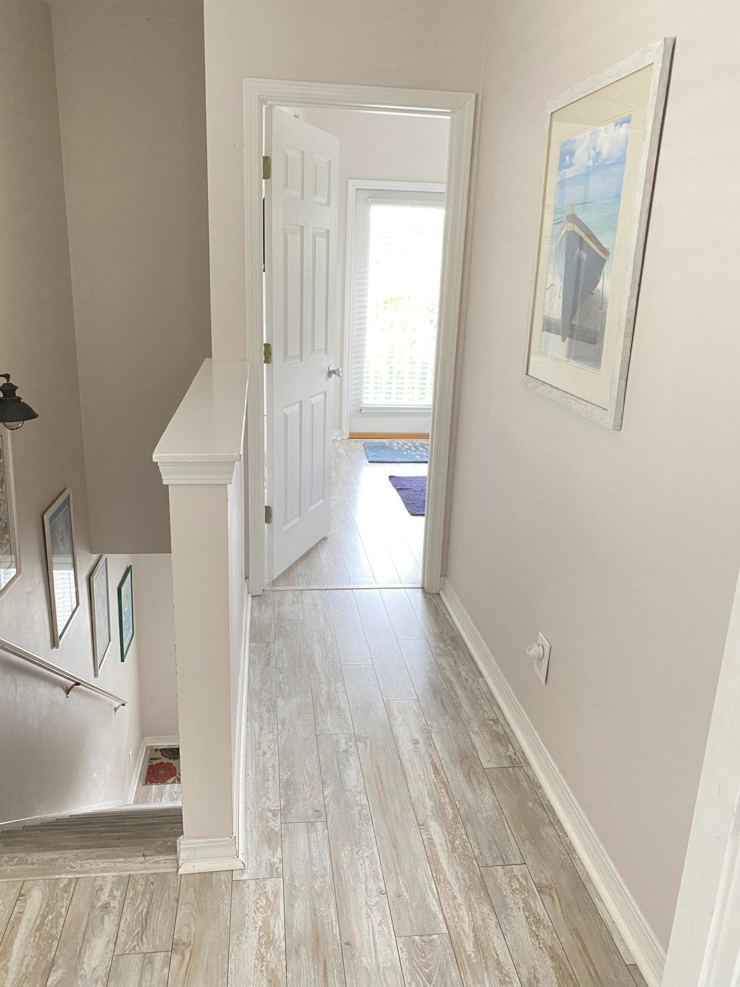 57 Emerald Dunes Circle Santa Rosa Beach, FL 32459 - Photo 10 of 26 a view of a hallway with wooden floor and cabinet