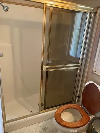 a bathroom with a toilet and a shower