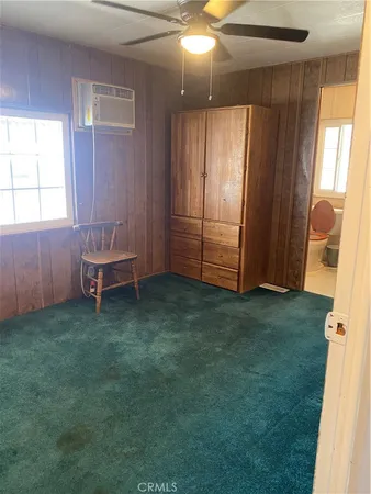 an empty room with a window and wooden floor