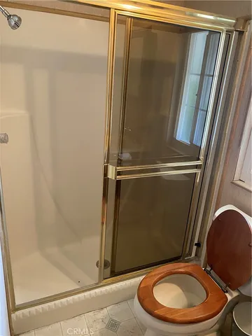 a bathroom with a toilet and a shower