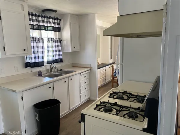 a kitchen with a stove cabinets and a window