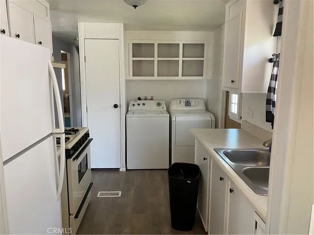 a kitchen with a refrigerator and a sink