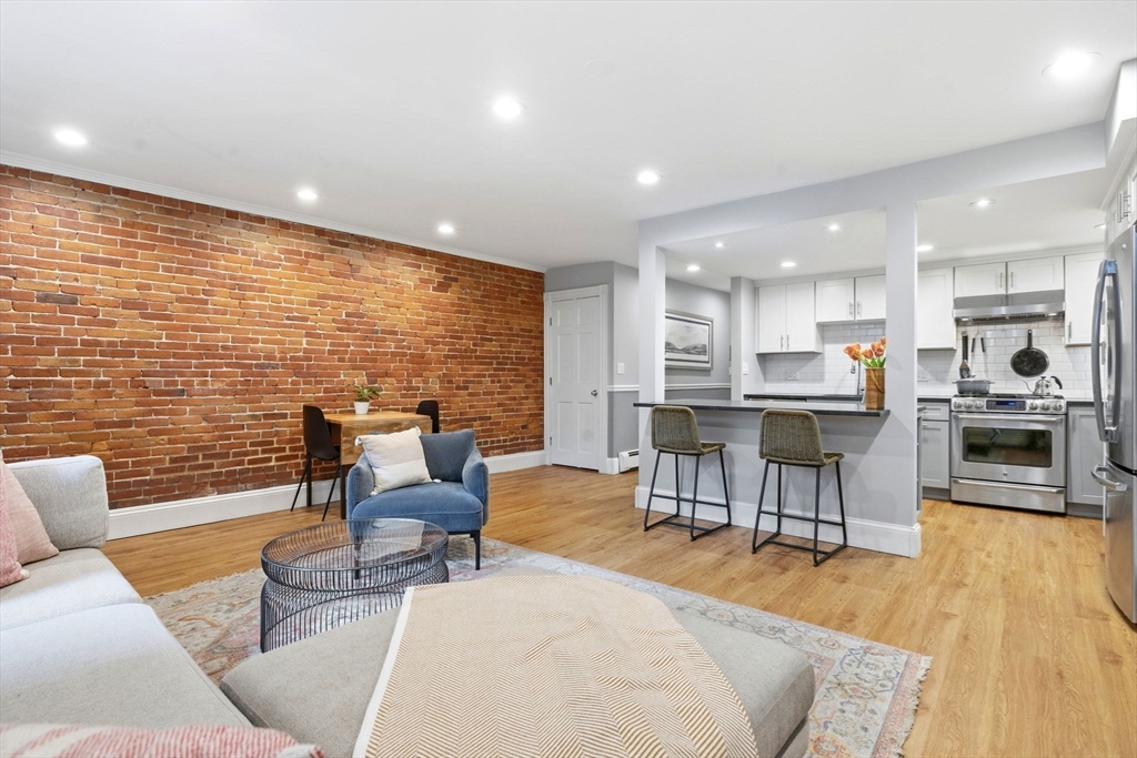 35 High Street, Unit 1 Boston, MA 02129 - Photo 28 of 33 a living room with fireplace furniture and a wooden floor