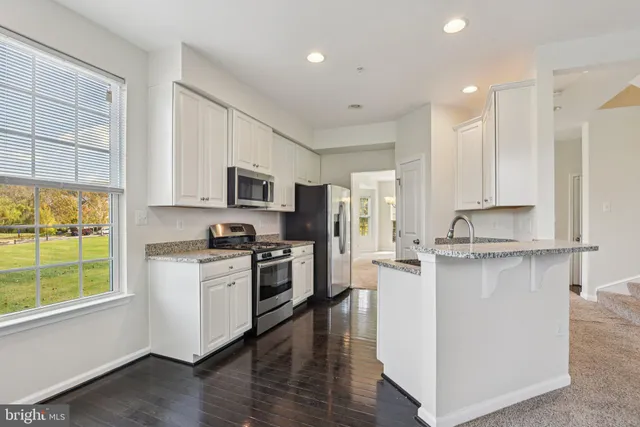a kitchen with a refrigerator stove and sink