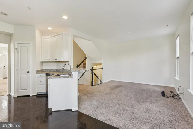 a view of kitchen with furniture and refrigerator