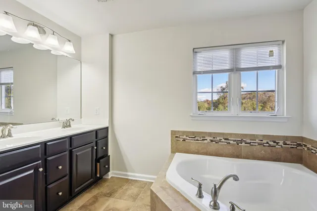a bathroom with a sink toilet tub and shower